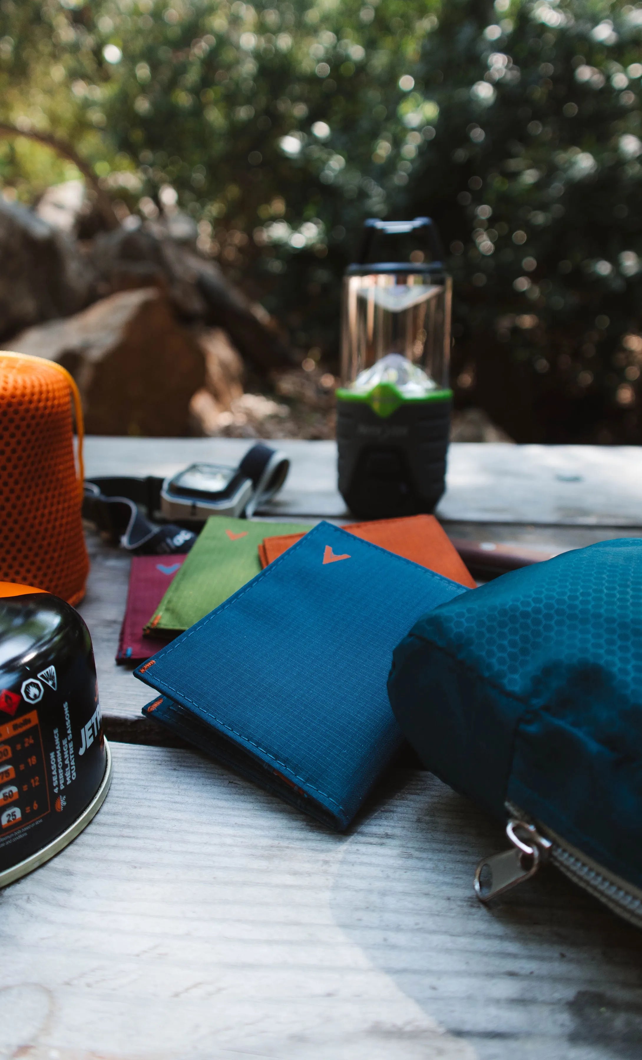 Multicolored vegan nylon Allett brand wallets laying on top of each other.