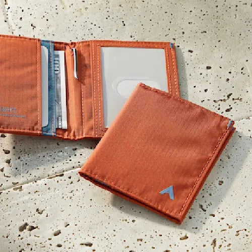 Photo is of one of Allett Wallet's slim card holder wallets. It is an orange/brown color made with ripstop nylon.
