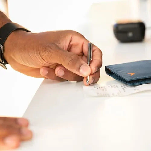 Photo shows an ultra-small wallet pen that fits in most wallets, including the pen pocket in our wallets at Allett.