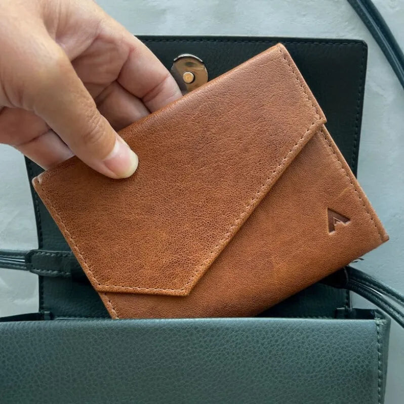 Envelope Wallet being pulled out of a small handbag