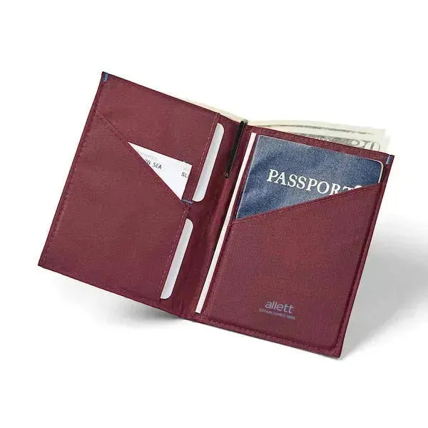 Displaying an open view, the mulberry nylon passport travel wallet houses a passport on the right, cards on the left, and a central micropen in its designated pocket. Allett Travel Wallet RFID Nylon - mulberry