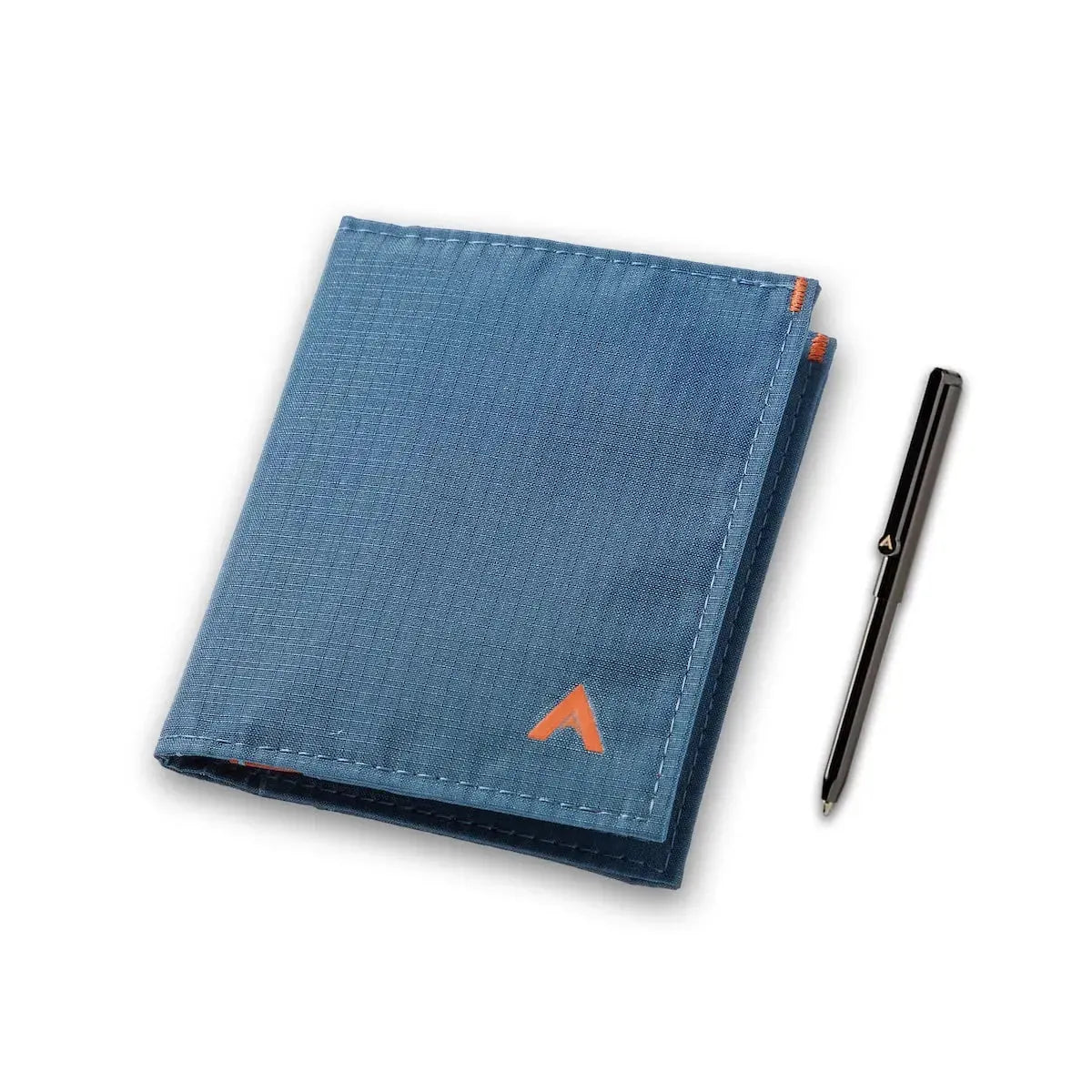 Indigo Blue hybrid card wallet by Allett, showcasing its thin design next to a micro pen. Allett Hybrid Card Wallet indigo-blue pen