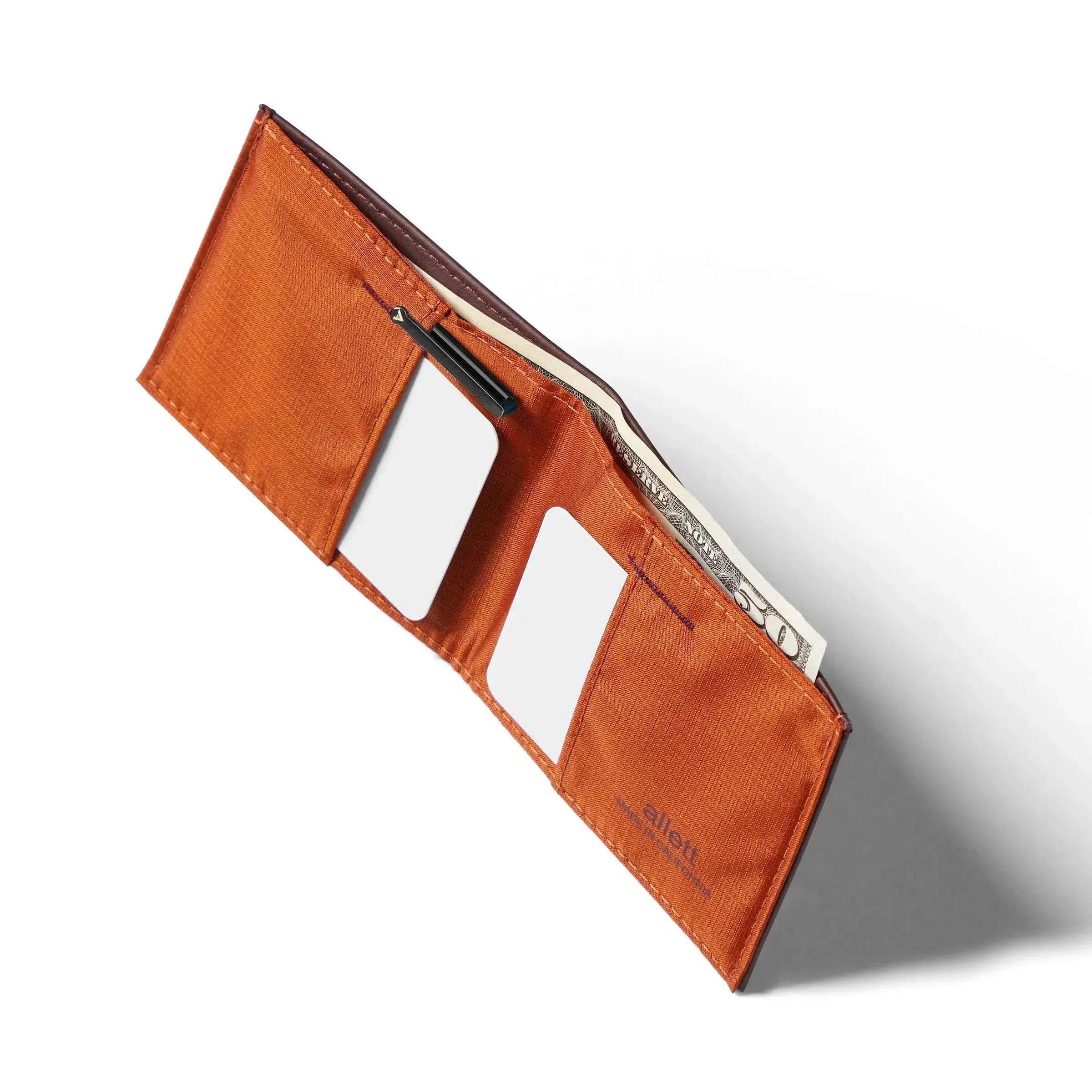 Upper view of an opened Nappa leather RFID blocking sports wallet to show cash pocket along with a card pocket on the left and the right. Allett leather sport wallet merlot