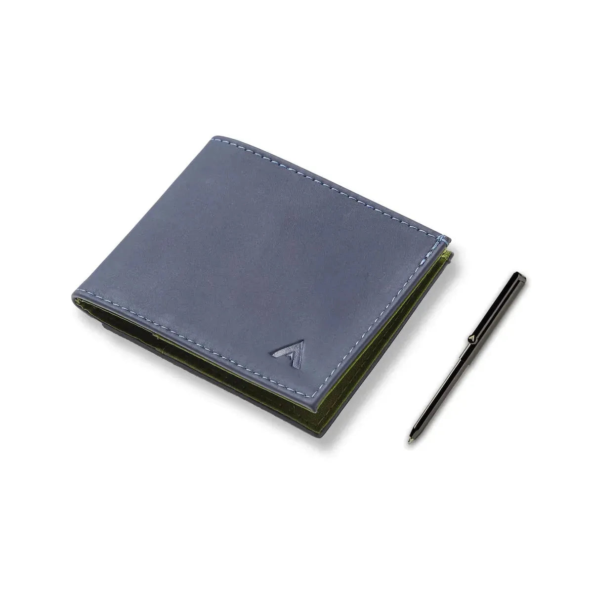 The midnight blue sports wallet, secured closed, positioned next to a micro pen on a stark white table. Allett Leather Sport Wallet midnight-blue pen
