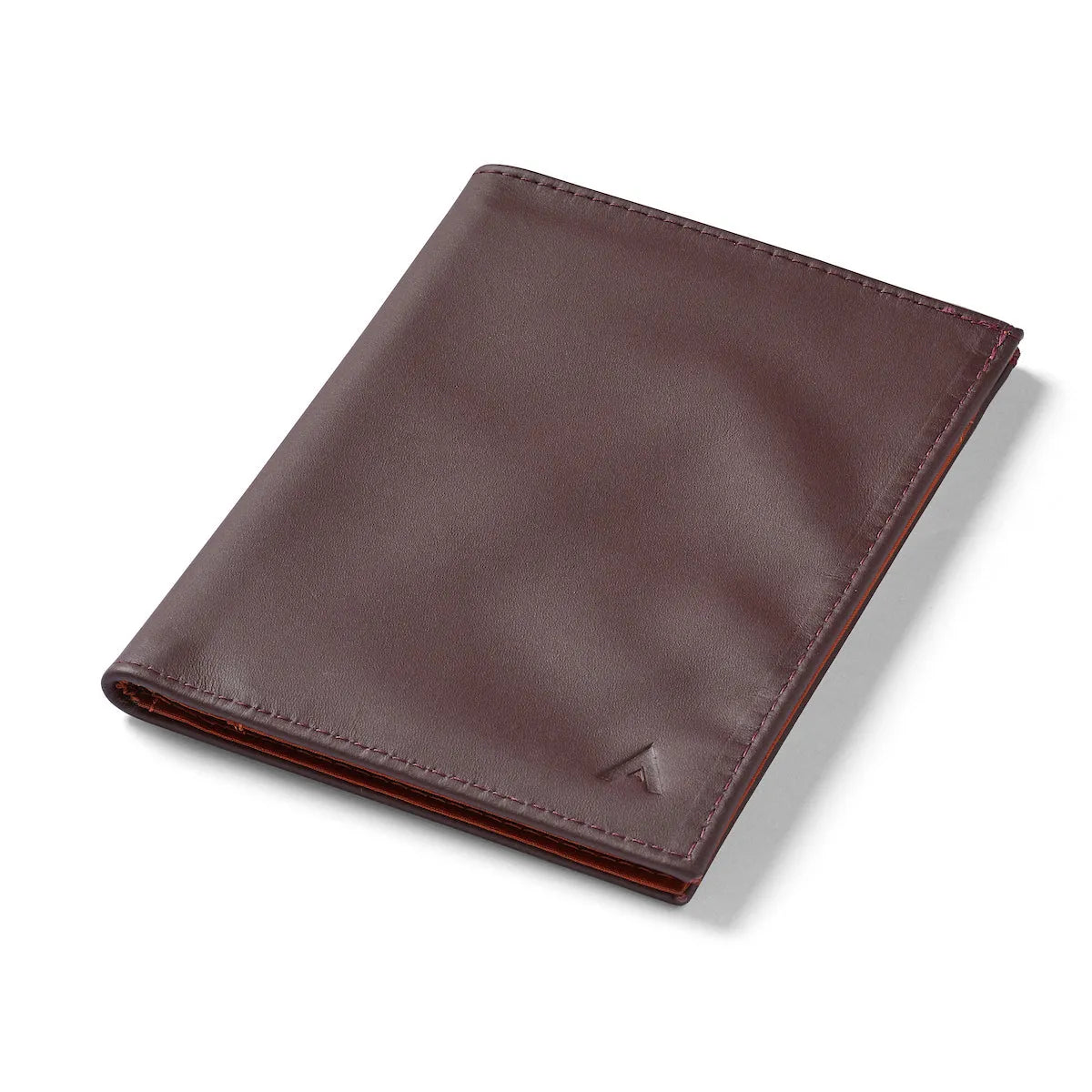 Closed merlot Nappa leather RFID wallet from Allett, set on a white background, with the brand's logo in the bottom right. Leather Travel Wallet by Allett - merlot