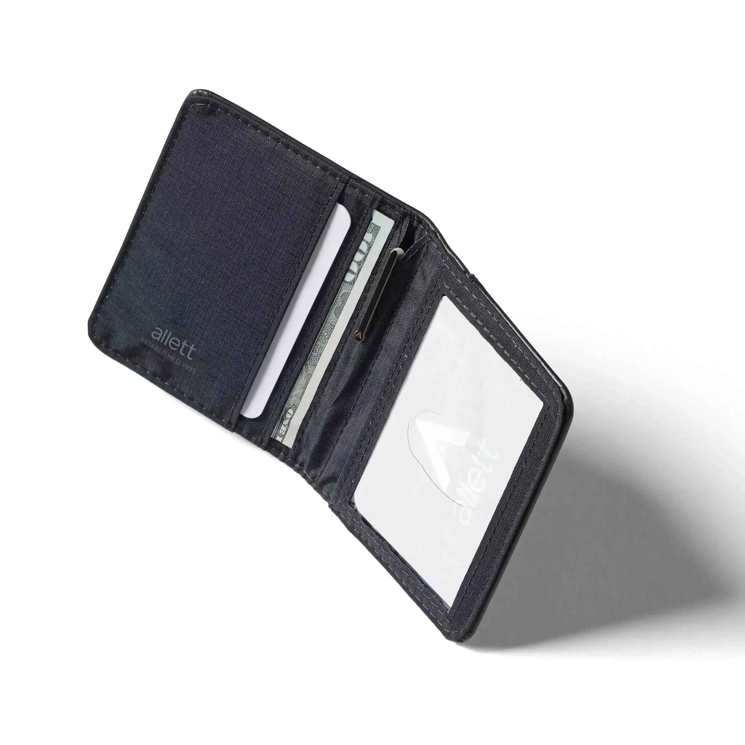 Open onyx black leather card wallet against a white background casting a shadow. onyx-black