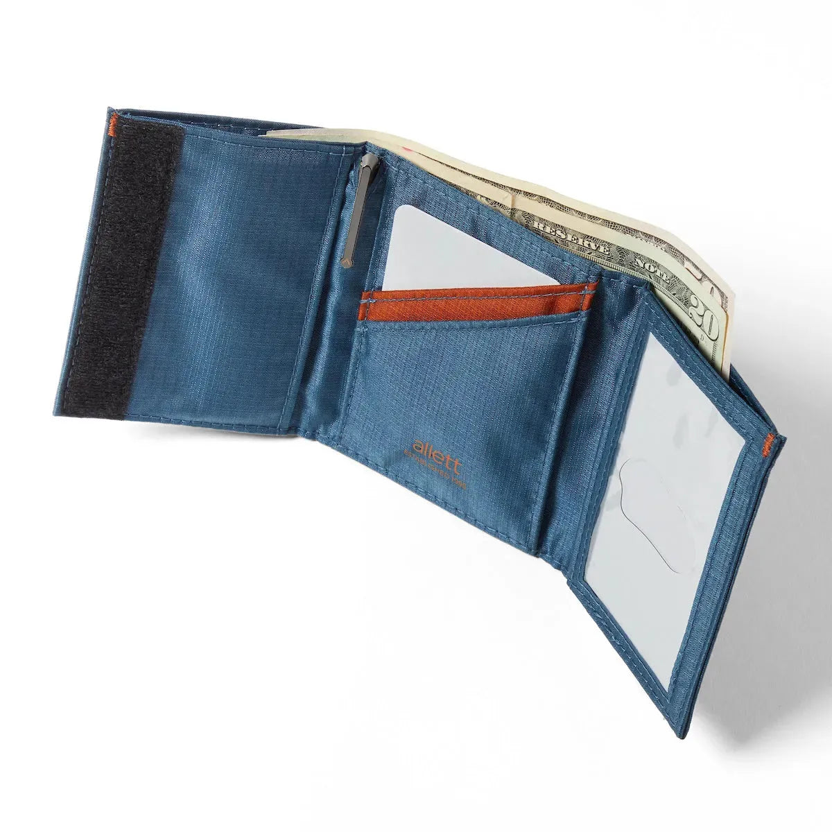 Openly presented trifold wallet in jet black, resting backward on a white surface, characterized by an ID slot on the right, a central card storage, and a velcro fastened left portion. Allett Trifold Wallet nylon edition - indigo-blue