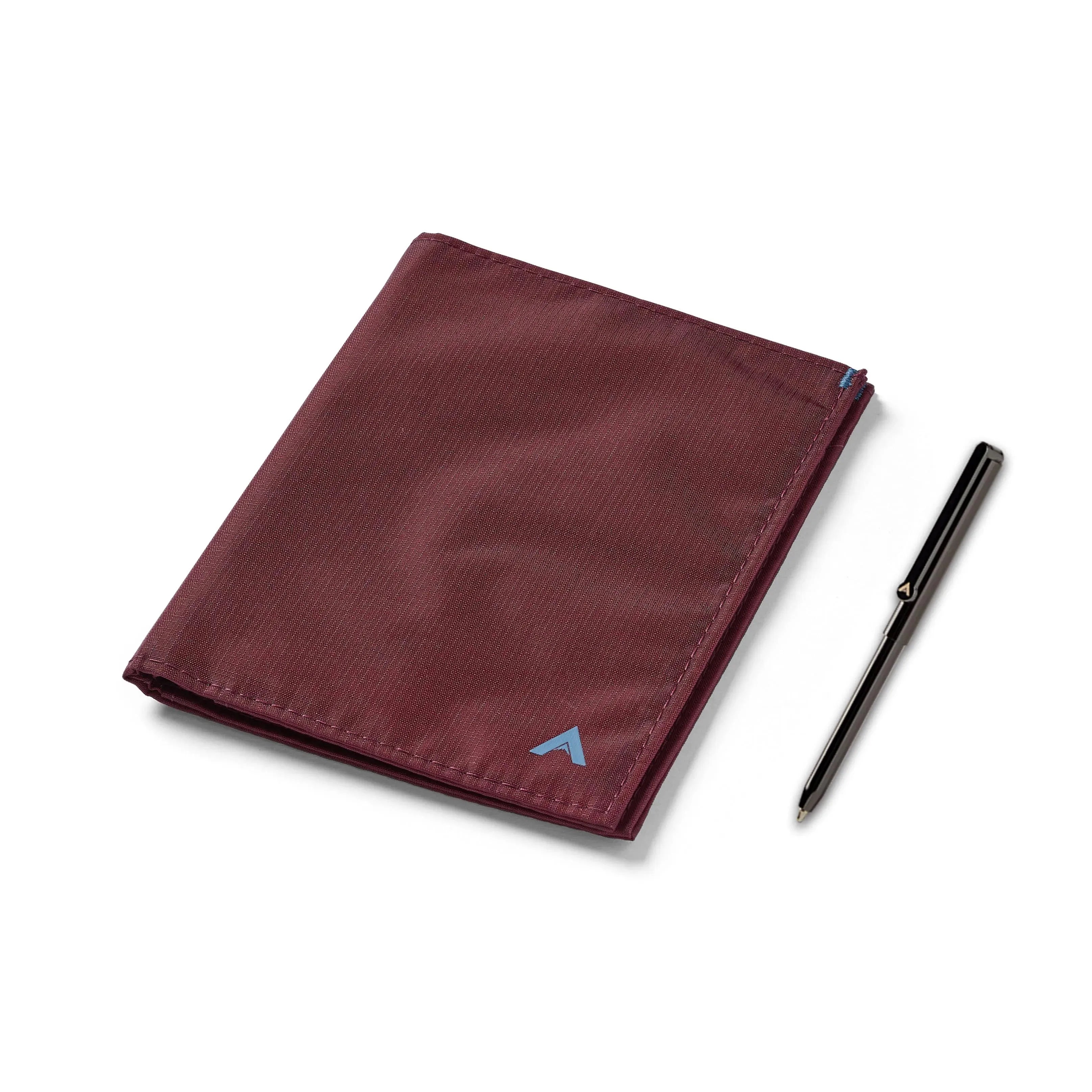 A large Travel Wallet from Allett wallet in mulberry with pen