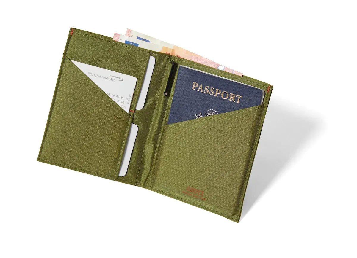 cala-green nylon travel wallet, unfolded to reveal a passport in the right compartment, cards on the left conveniently lodged in the central fold pocket. Cash located in cash pocket. Allett Travel Wallet RFID Nylon - cala-green