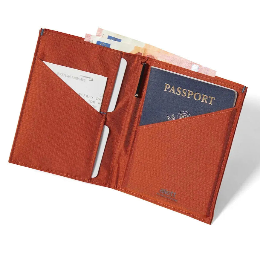 nylon travel wallet, unfolded to reveal a passport in the right compartment, cards on the left conveniently lodged in the central fold pocket. Allett Travel Wallet RFID Nylon - potters-clay