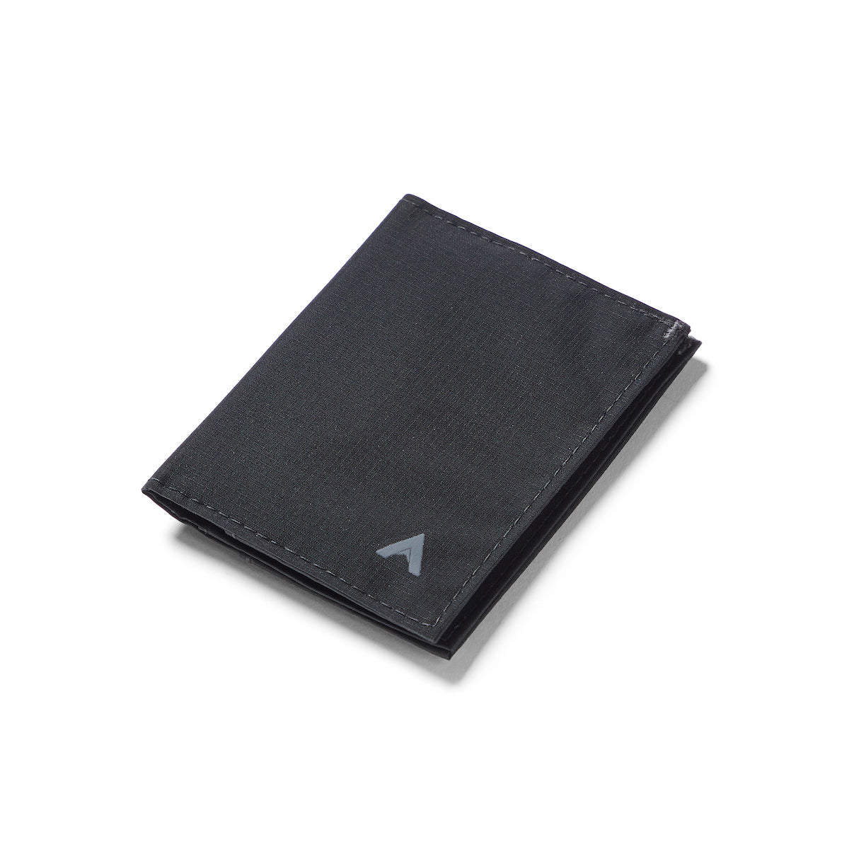 Ultra-slim Jet Black hybrid card wallet, crafted from ripstop nylon, presented closed against a plain white backdrop. Allett Hybrid Card Wallet jet-black