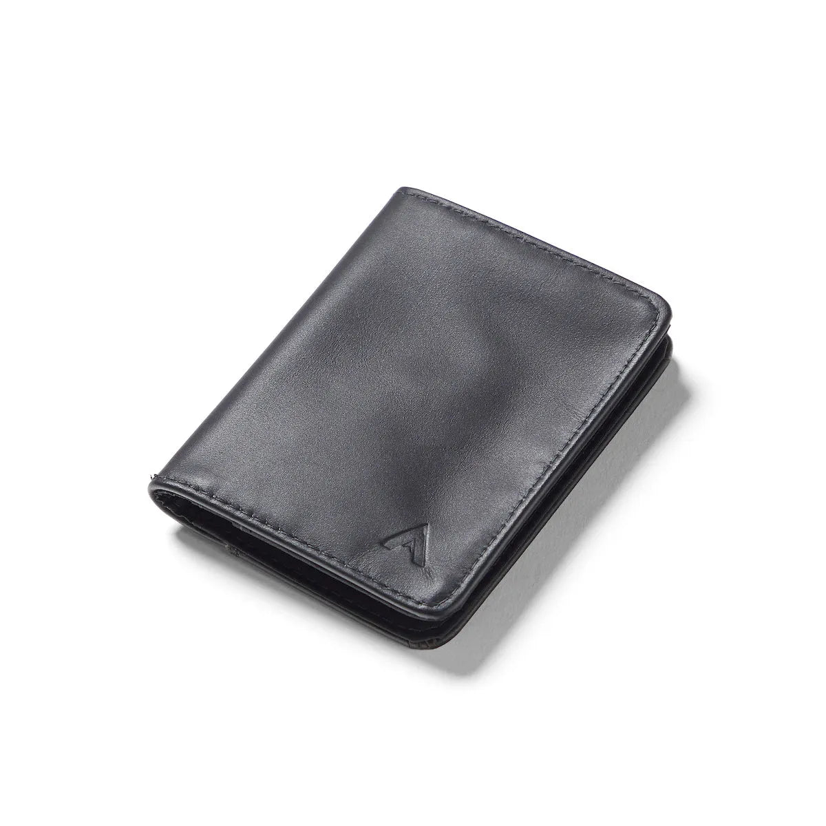 Onyx black leather hybrid card wallet against a white background, sitting closed. Leather hybrid card wallet onyx-black