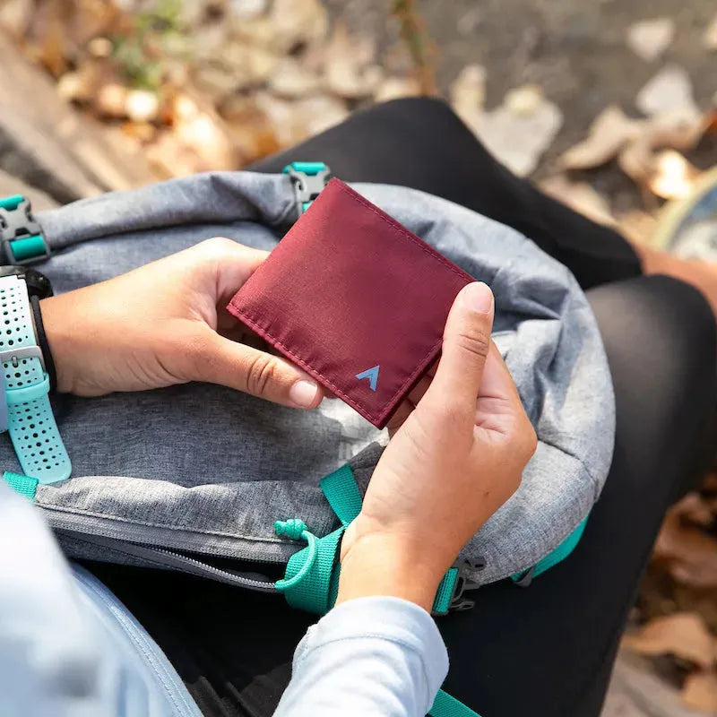 Hands holding a closed and empty nylon sports wallet with a light blue A for the Allett logo - Allett Sport Wallet RFID Nylon Front Pocket Wallet mulberry