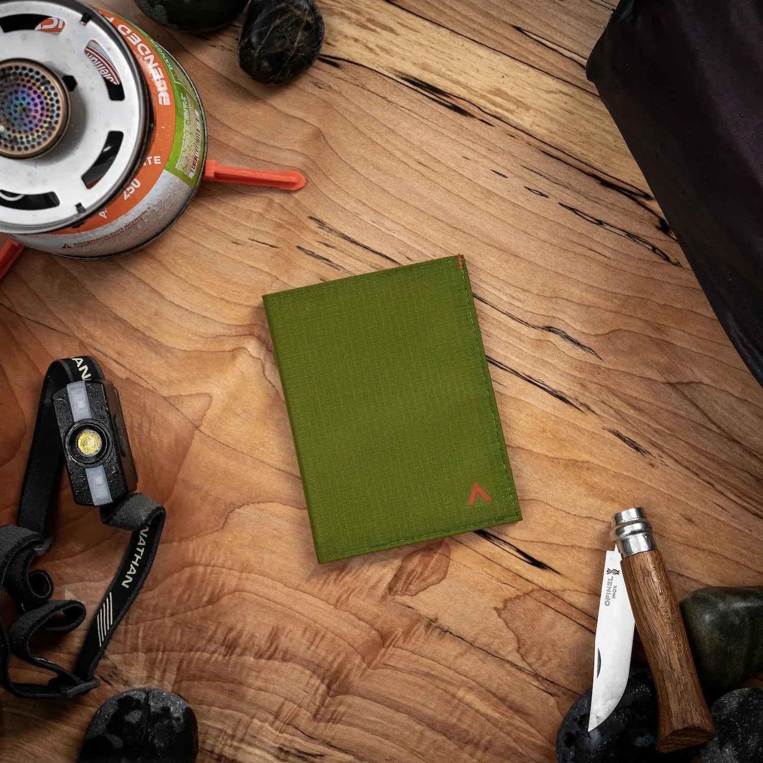 Aesthetic view of the minimalist vegan nylon wallet on a table cala-green