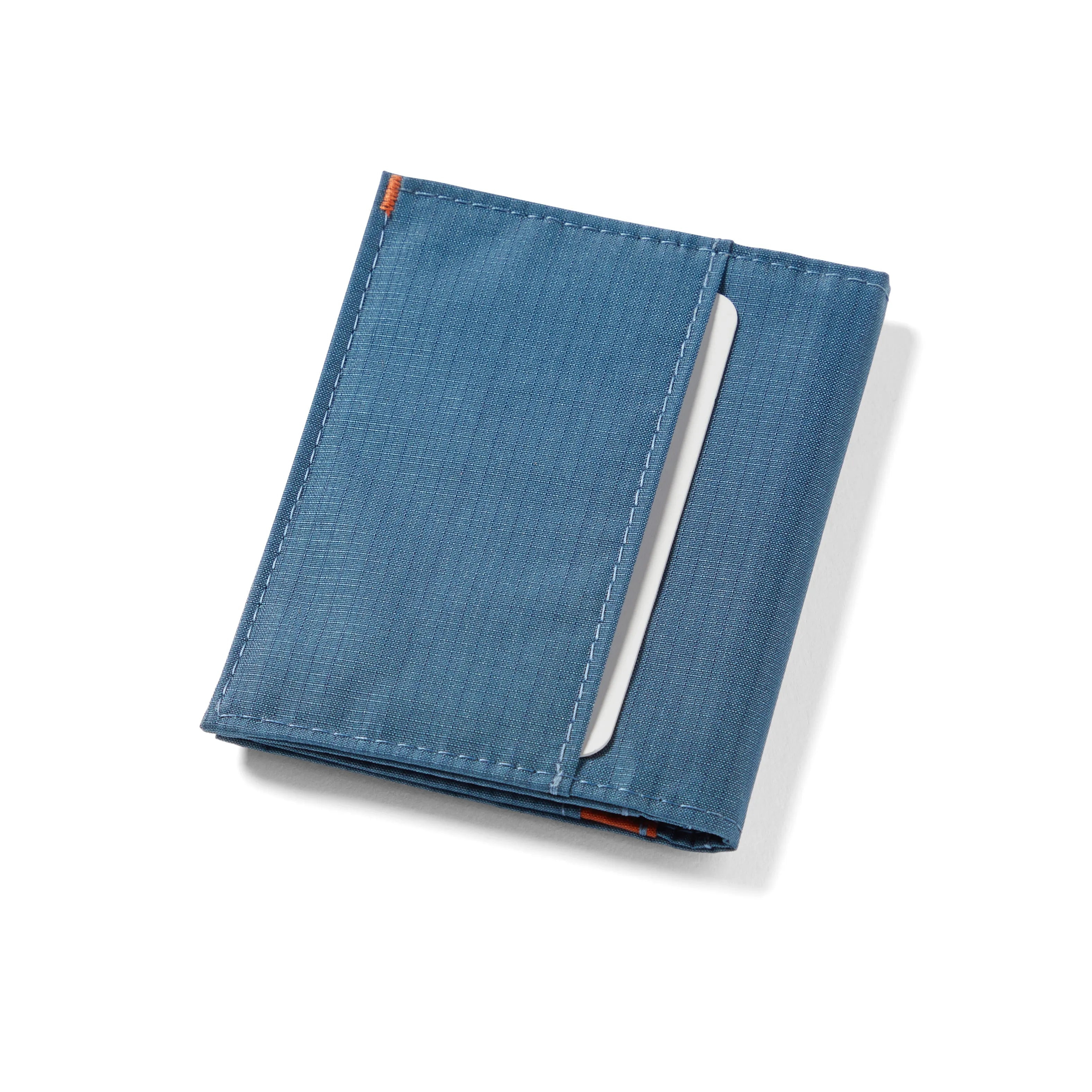 Closed Indigo Blue hybrid card wallet, revealing an external pocket fit for cards and cash folding. Allett Hybrid Card Wallet indigo-blue