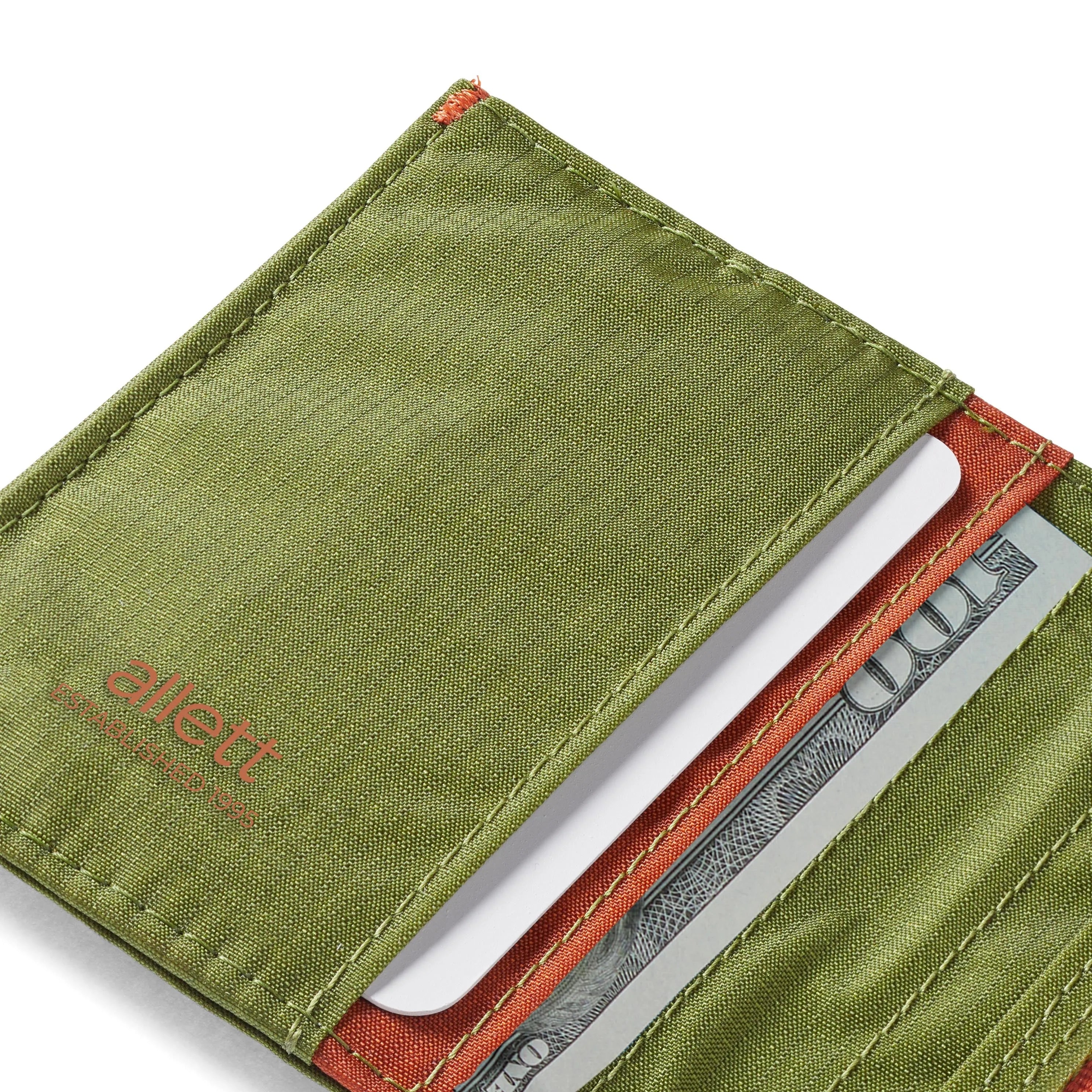 Sectioned view of Cala Green hybrid card wallet by Allett, highlighting the card slot and intricate stitch work. Allett Hybrid Card Wallet cala-green