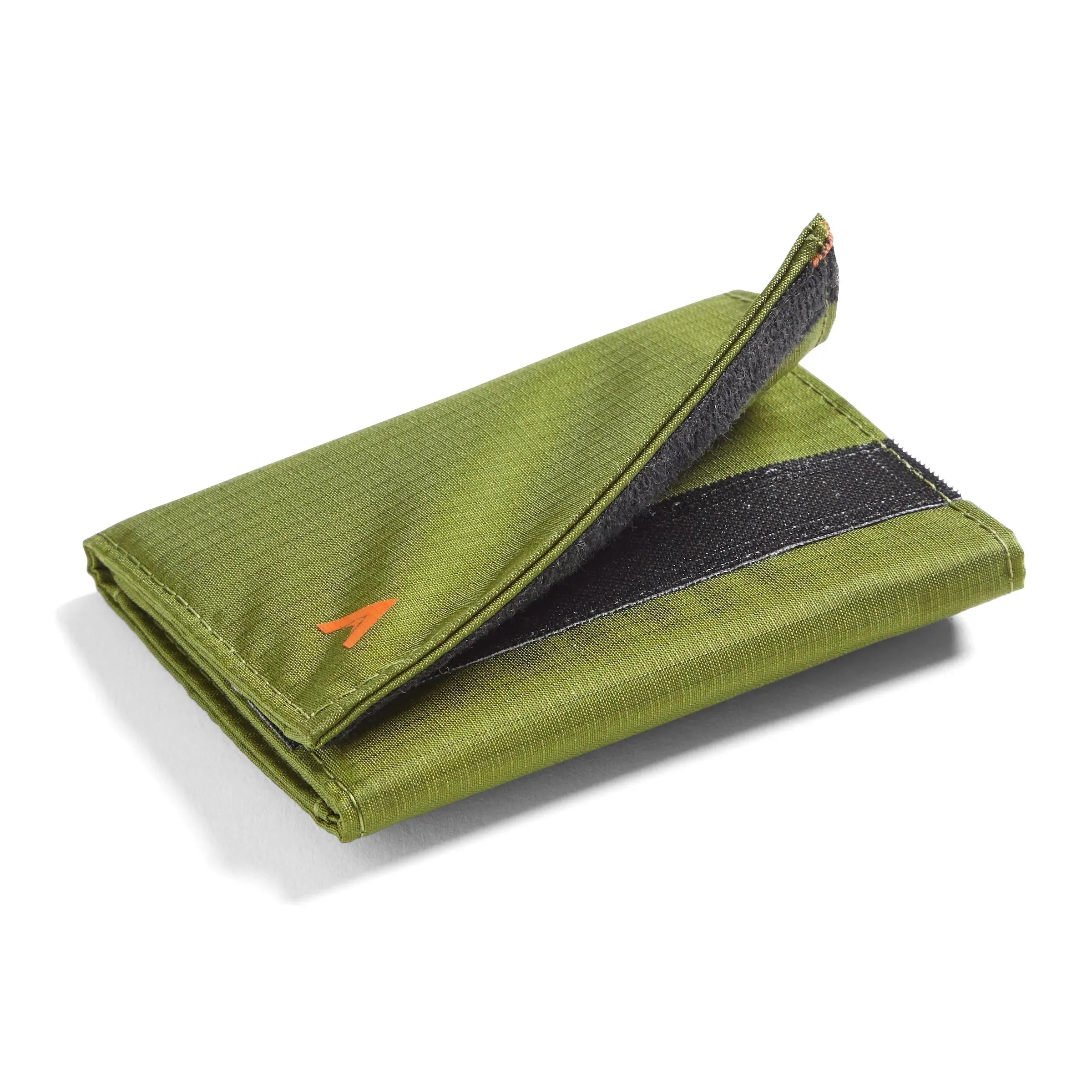Partially opened velcro flap of a cala green nylon trifold wallet, depicted in a modest close-up against a white field. allett trifold wallet cala-green