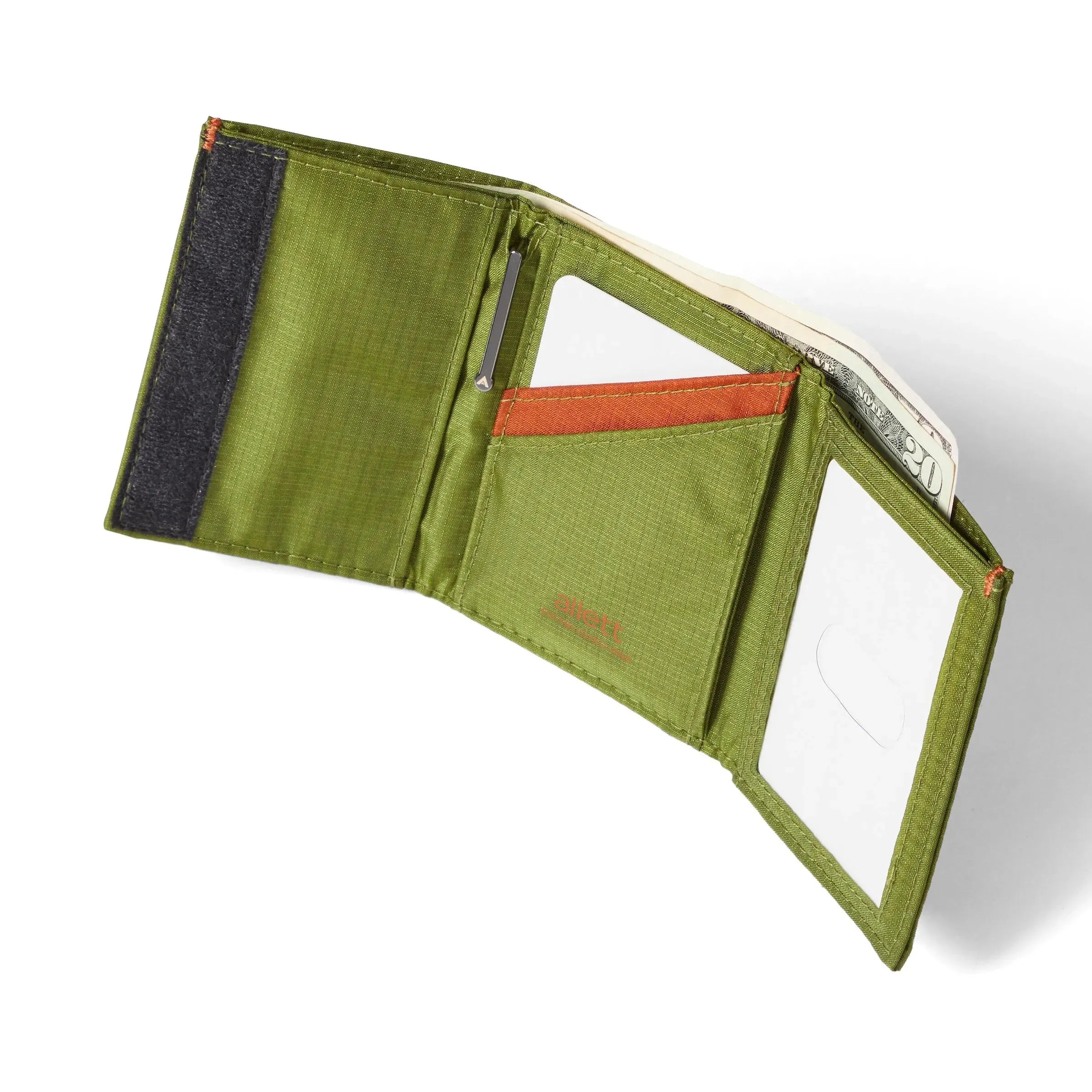 Cala green trifold wallet, open and reclining against a clean white backdrop, unveiling an ID pocket to the right, a card chamber in the center, and a velcro section on the left. allett trifold wallet cala-green