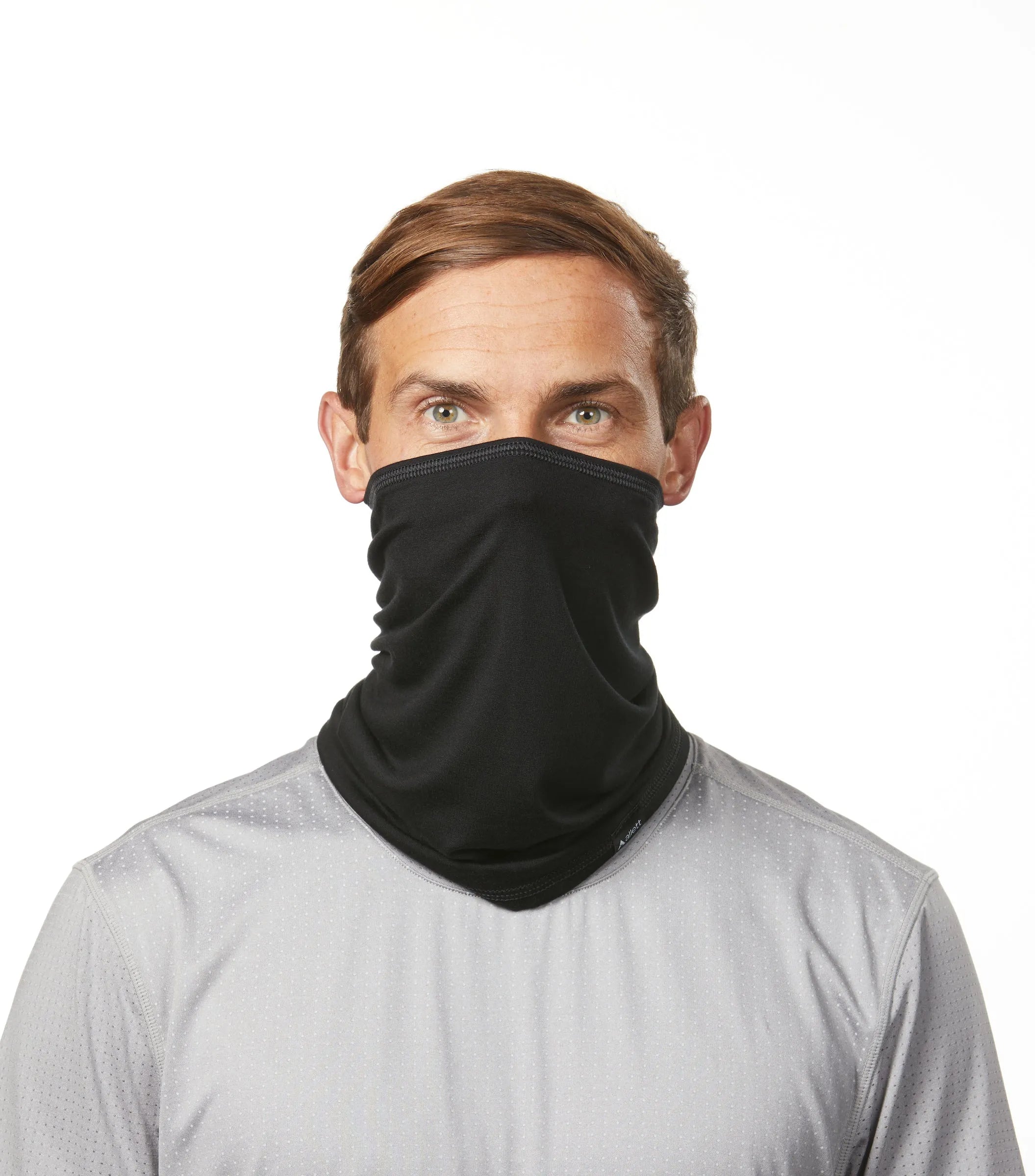 Man wearing the black Allett Beechwood neck gaiter fabric face covering. black