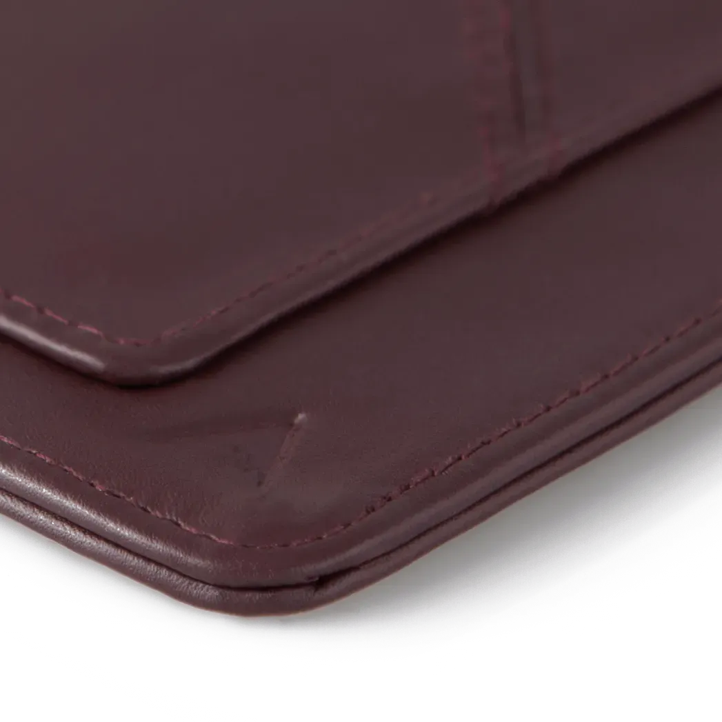 Close up of the unique soft rounded corner of the oxblood colored leather wayfinder travel wallet. Allett Wayfinder Leather Wallet - oxblood