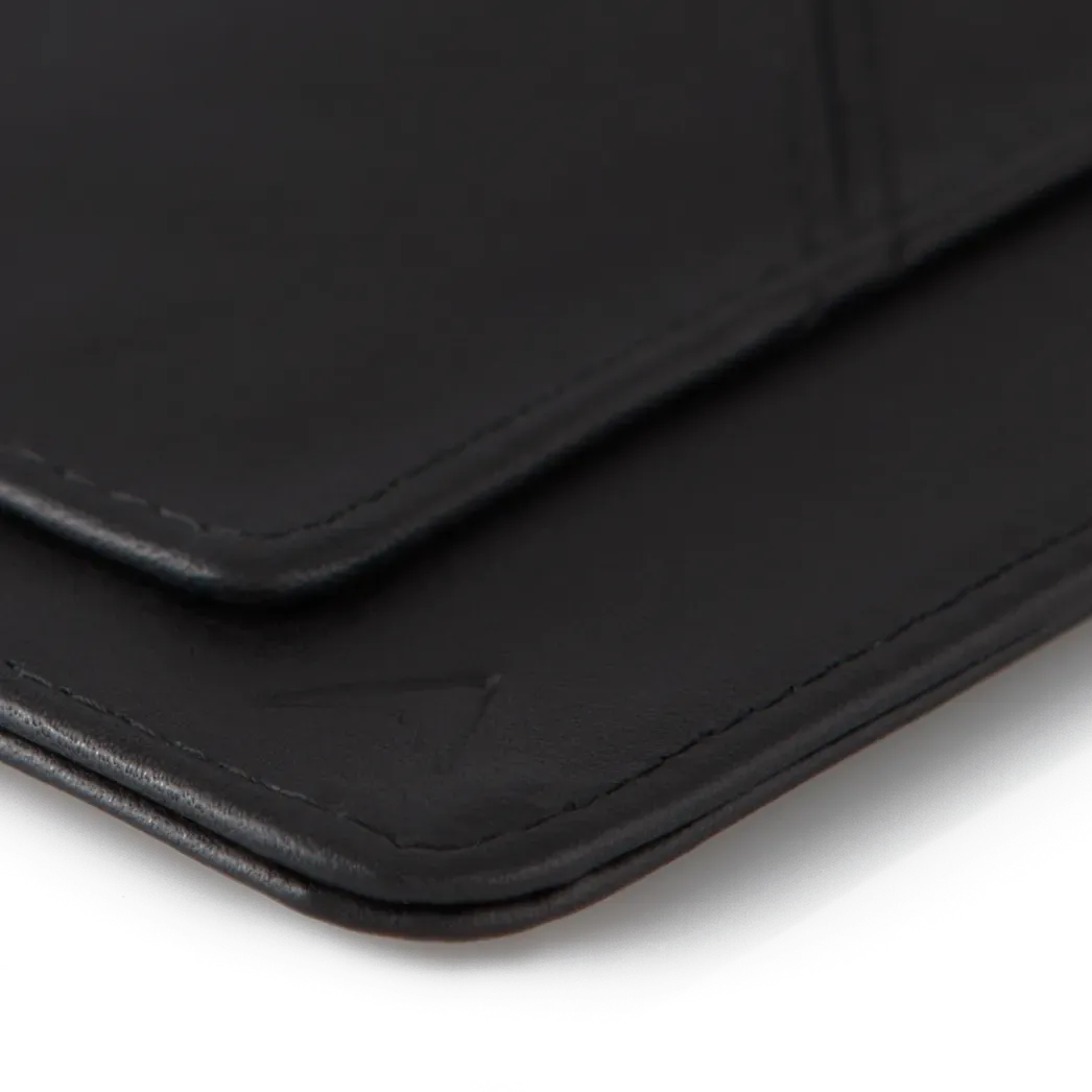 A detailed perspective of the black leather wayfinder travel wallet, showcasing the distinctive soft curve at the corner. Allett Wayfinder Leather Wallet - black
