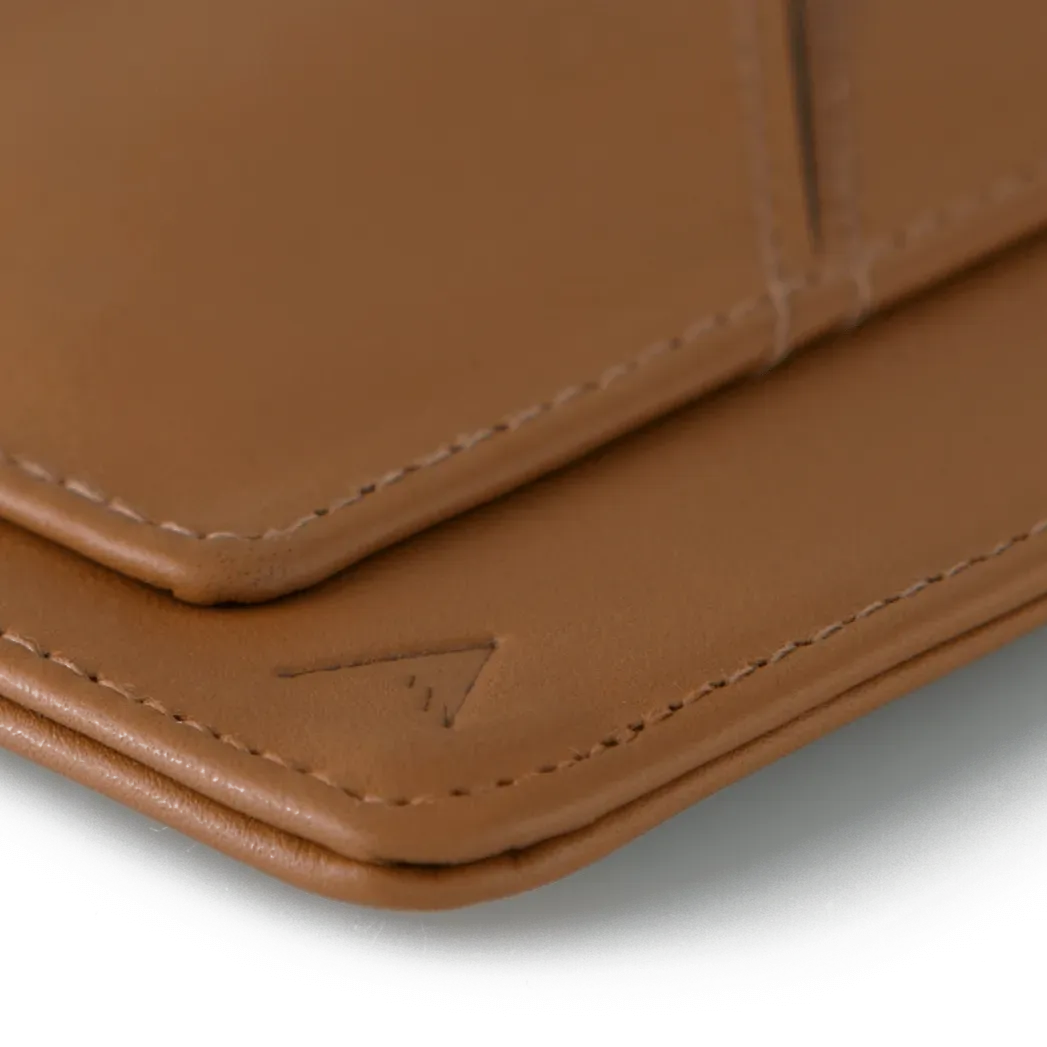 Zoomed in view of the brown leather wayfinder travel wallet, revealing its uniquely soft and rounded corner. Allett Wayfinder Leather Wallet - brown
