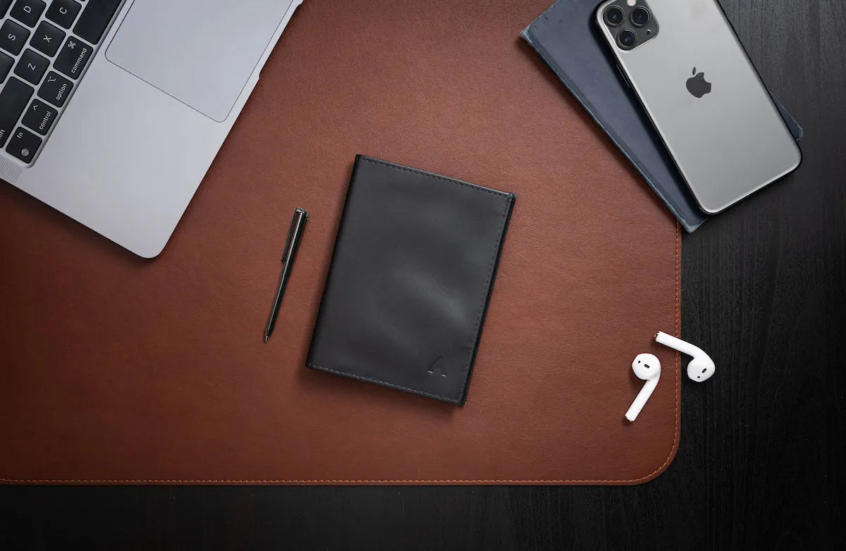 Allett Wallet next to laptop, phone and airpods