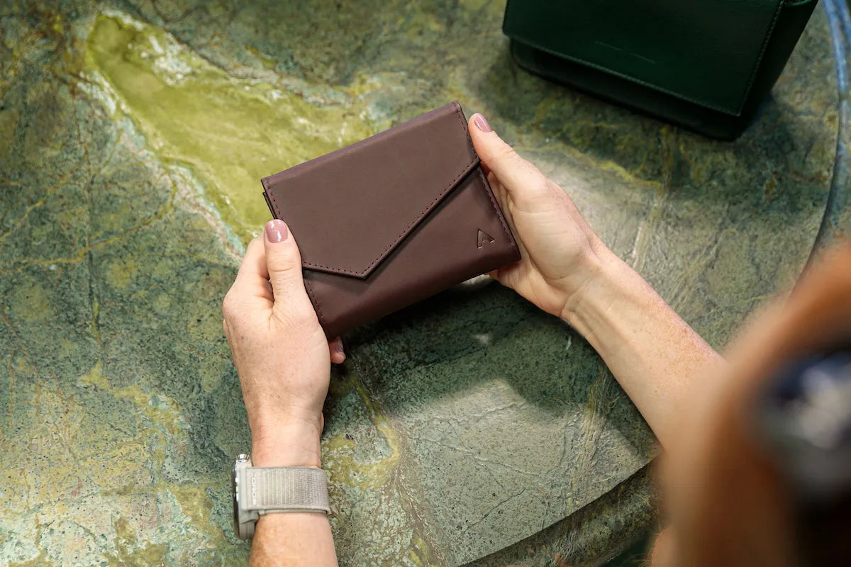 Woman holding envelope wallet from Allett
