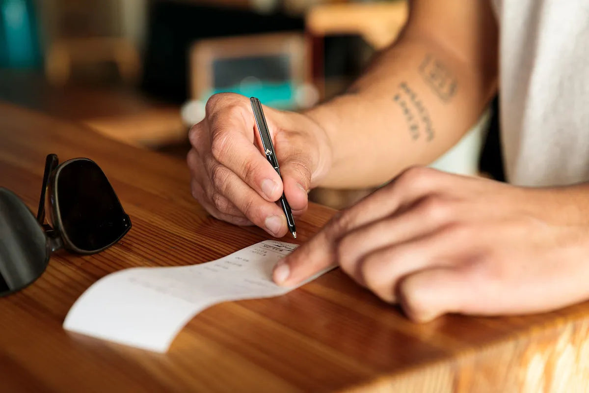 man writing  with micro pen