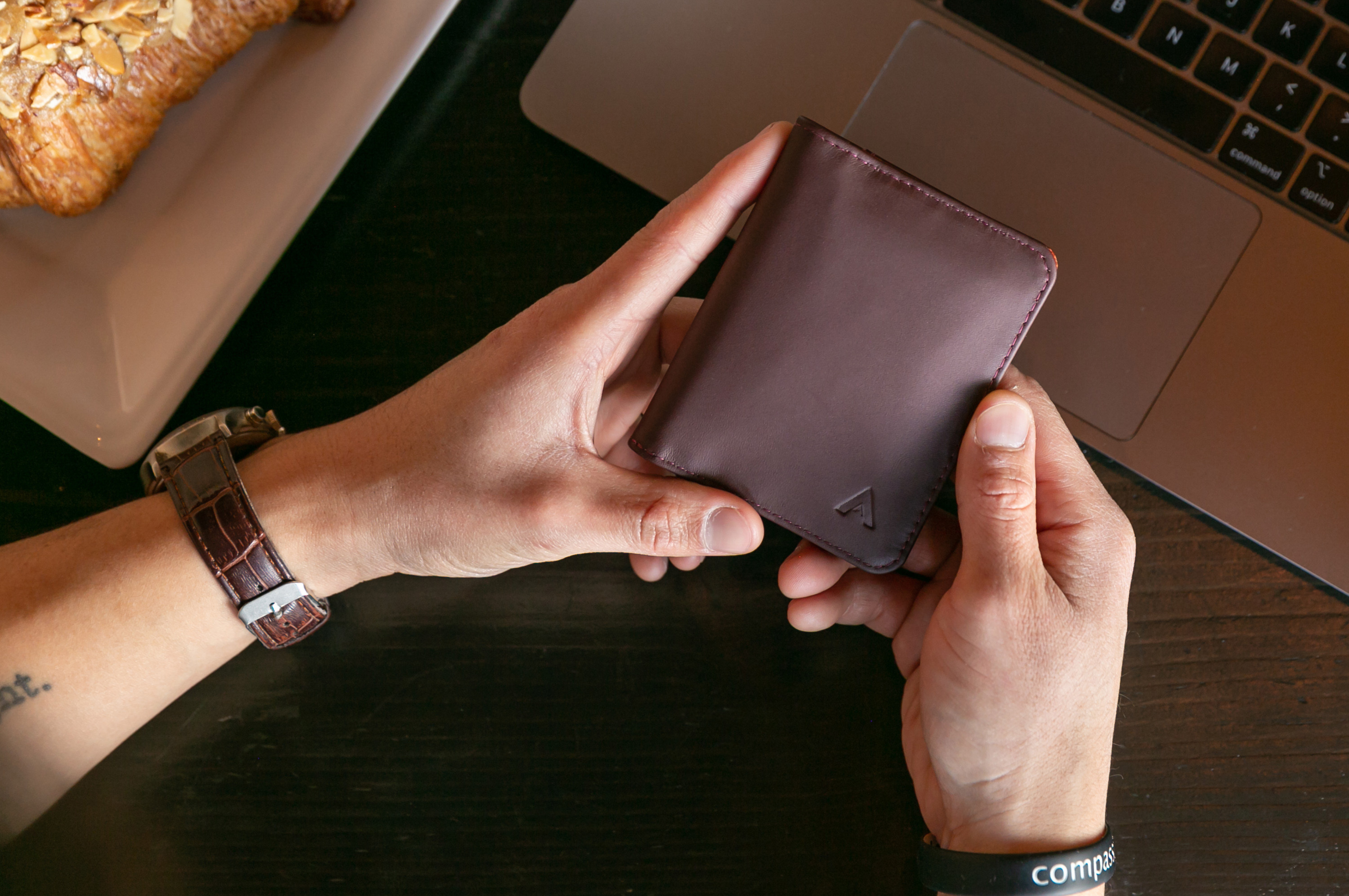 Hands holding a premium leather wallet Premium Gifts over $50 by Allett Leather Wallets and Travel Sling Bags