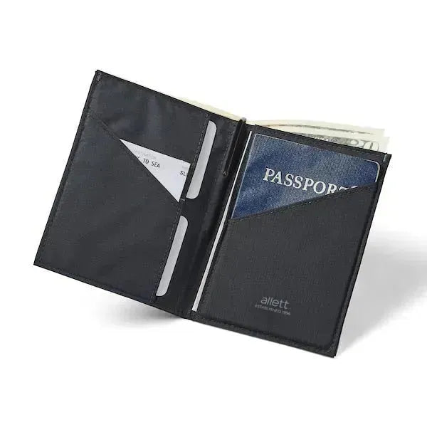 Jet black nylon travel wallet, unfolded to reveal a passport in the right compartment, cards on the left conveniently lodged in the central fold pocket. Allett Travel Wallet RFID Nylon - jet-black