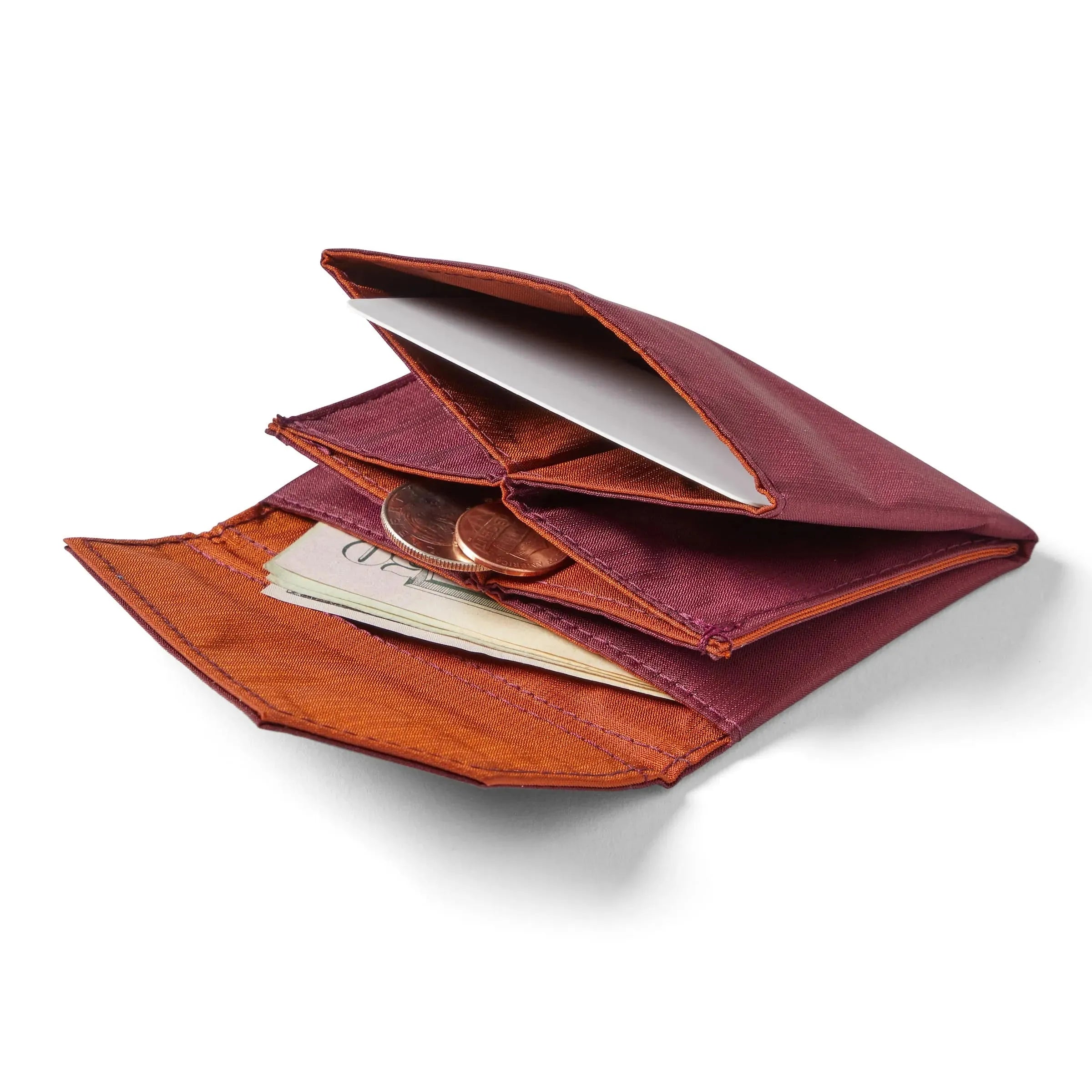 Allett's ripstop nylon premium accordion wallet laying open and flat against a white background, with coins and cash slightly protruding from the interior pockets. Allett Accordion Wallet in RFID Blocking Nylon  mulberry