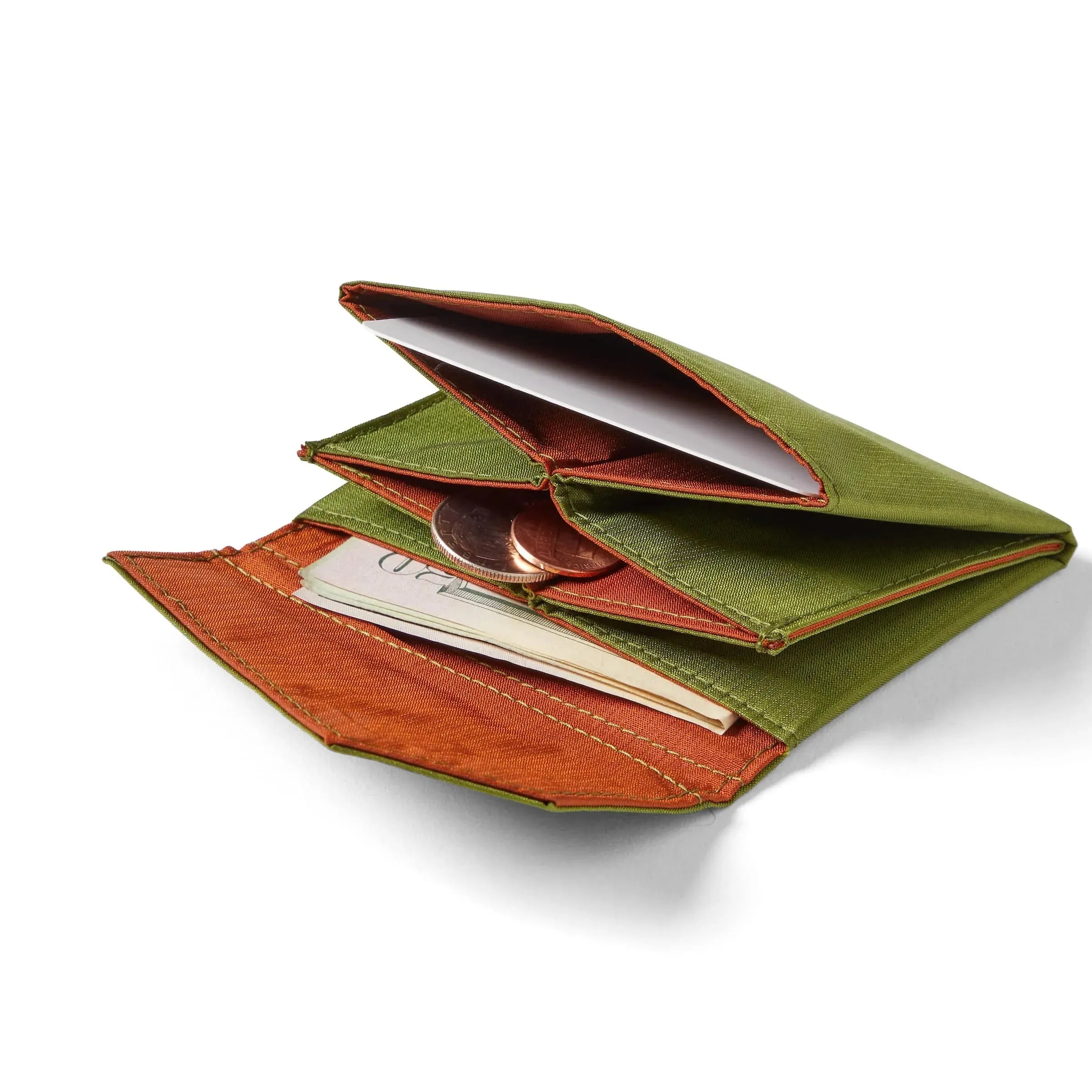 The cala green ripstop nylon accordion wallet from Allett, laying open on white, with coins and bills slightly visible from the wallet's clay color interior. Allett Accordion Wallet in RFID Blocking Nylon cala-green