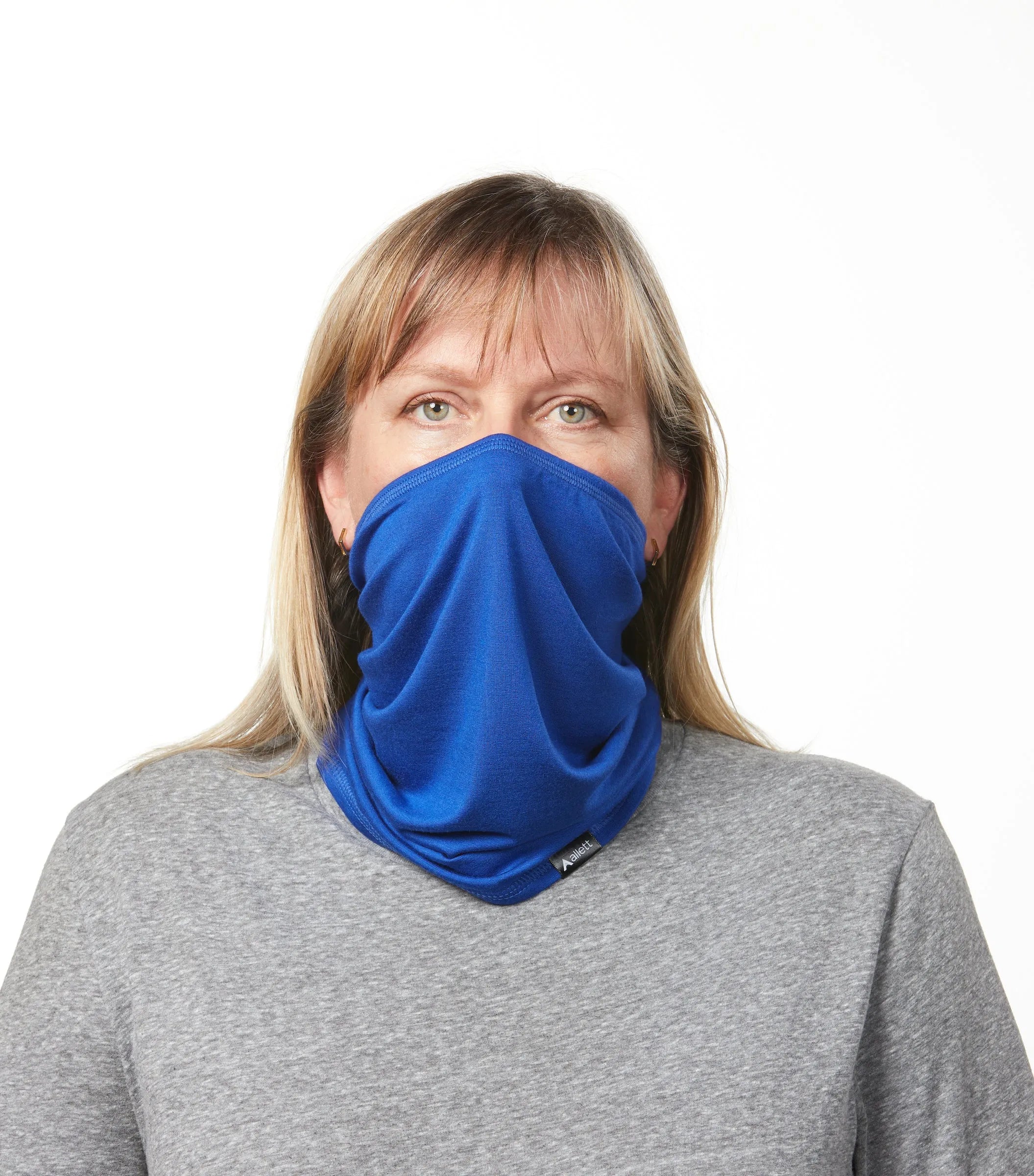 Woman facing forward in grey shirt wearing a cobalt blue neck gaiter. cobalt-blue