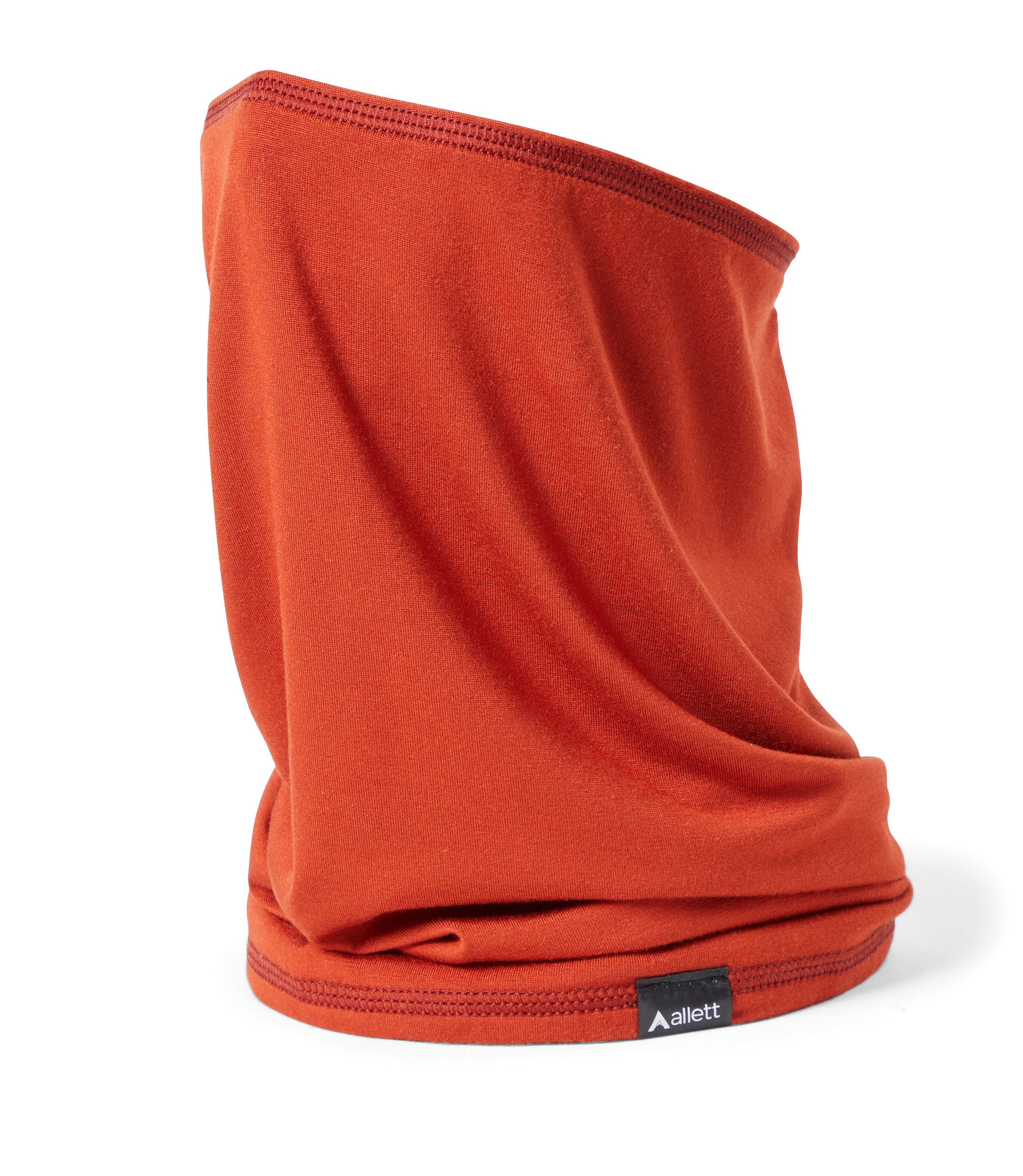 Reddish color (known as "rust") neck gaiter that made of raw plant fabric. rust