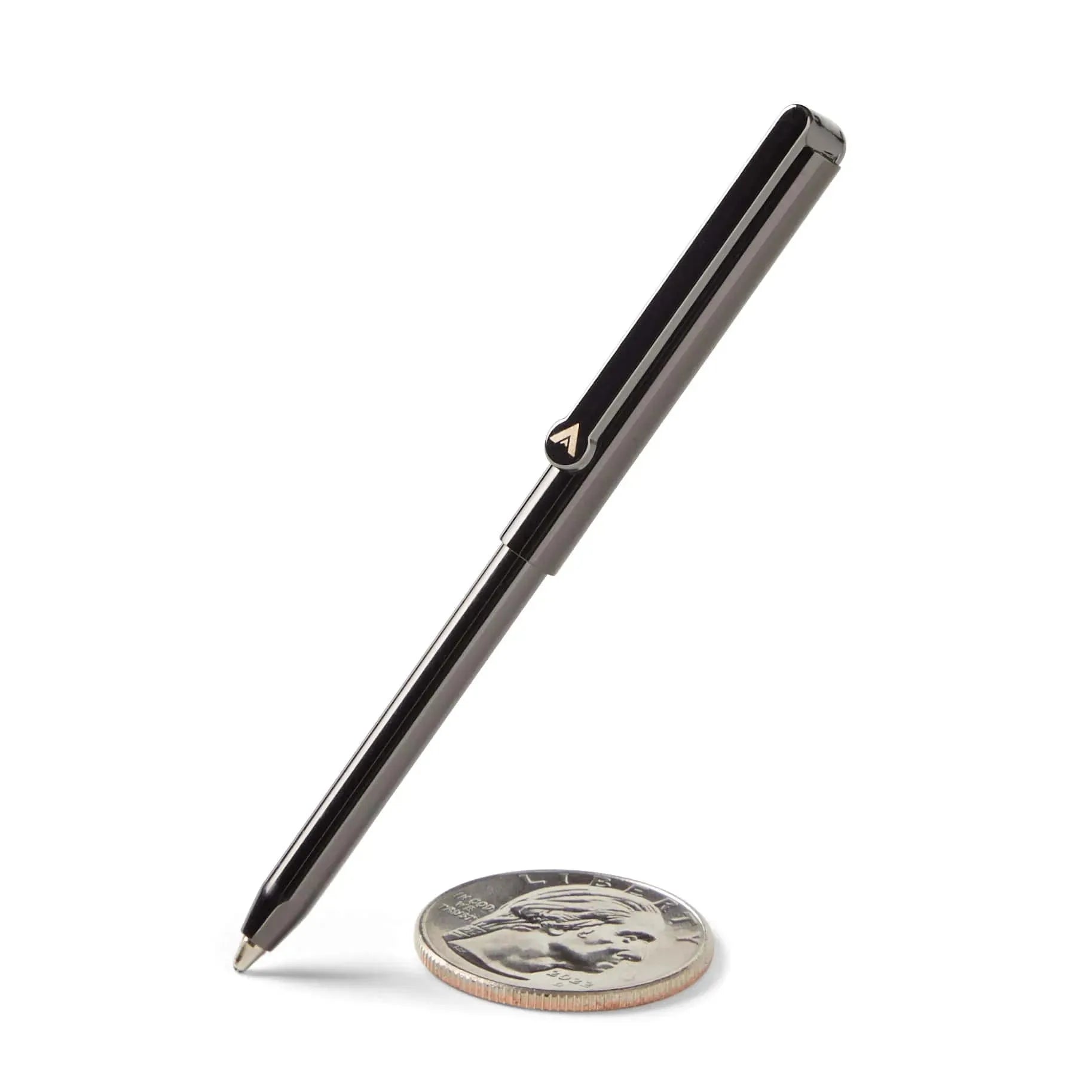 Allett Micro Wallet Pen standing next to quarter coin for size comparison, brass with a gunmetal finish