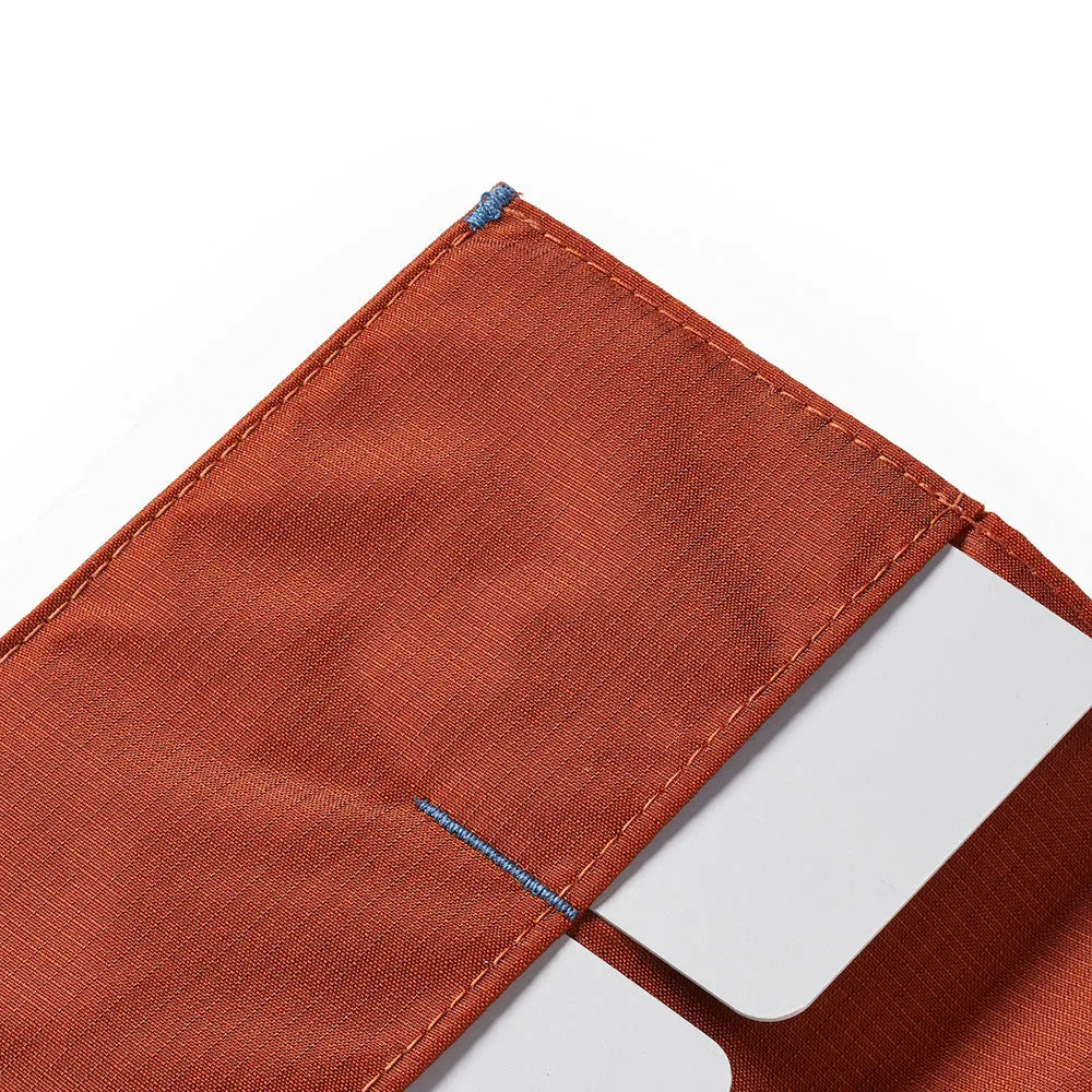 A detailed close-up of one corner of the Allett Wallet original nylon wallet in potters-clay
