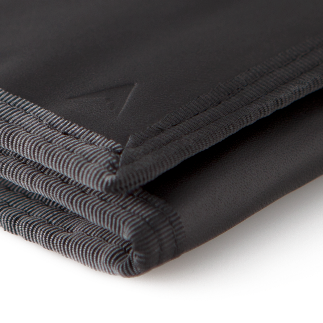 Close-up of the acute corner of the black leather "Switchback" trifold wallet, highlighting the Allett logo. Allett Switchback Leather Wallet - black