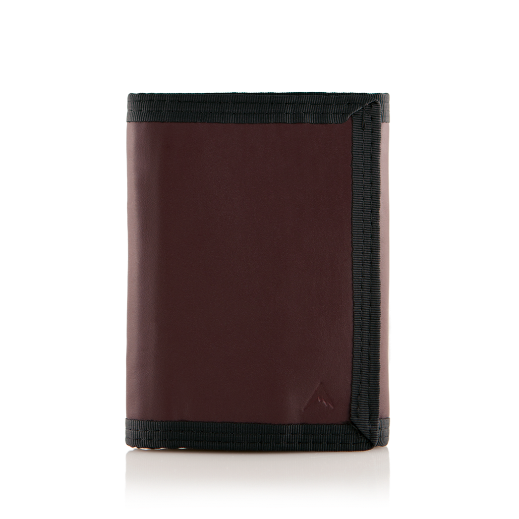 Oxblood leather "Switchback" trifold wallet with trim, closed, set against a neutral white background. Allett Switchback Leather Wallet - oxblood