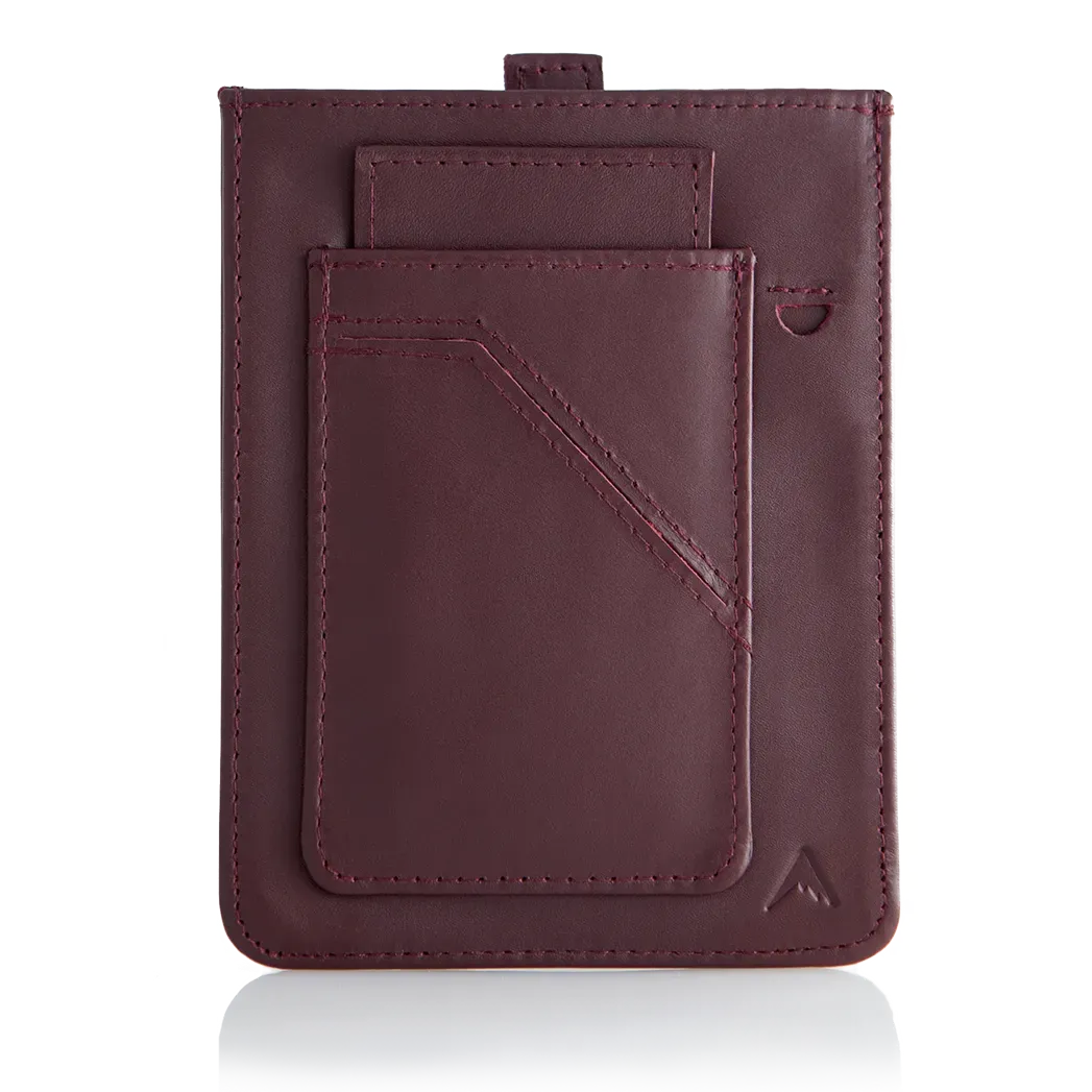 An oxblood version of Allett's wayfinder leather wallet, highlighting a distinct pull-tab mechanism for card retrieval and advanced RFID security. The visible exterior pocket, designed to accommodate several cards, is noticeably empty. Allett Wayfinder Leather Wallet - oxblood