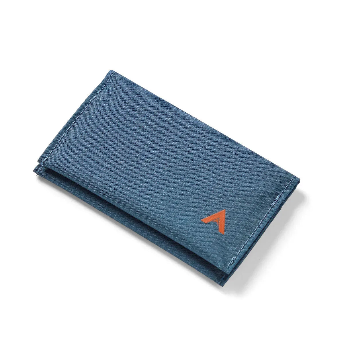 Allett's minimalist and vegan indigo blue ripstop nylon card wallet, displayed in its closed position on a clean, white background. - indigo-blue